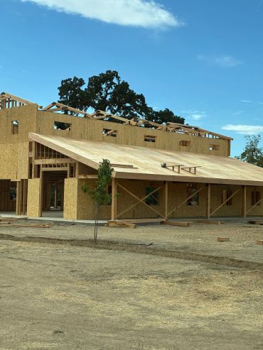 Wooden building under construction on a clear day.
