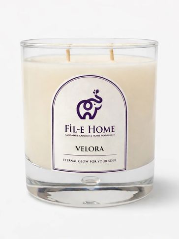 Glass candle with two wicks from Fil-e Home, labeled Velora.
