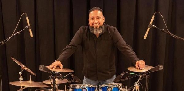 Mike Gonzalez & The Iconiczz drummer behind a blue DW drum kit during a live studio session.