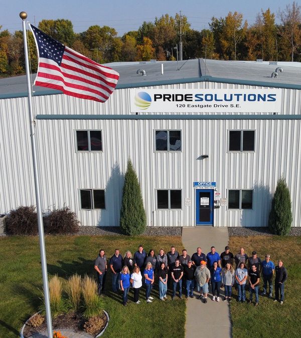 Aerial view of Pride Solutions employees standing in front of manufacturing facility. 