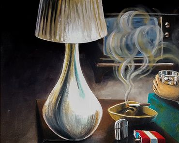 A lit cigarette in an ashtray beside a lamp on a table.