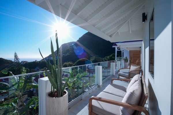 Scenery Hotel, Saba Dutch Caribbean.
Sunlit balcony with comfortable chairs overlooking lush greener