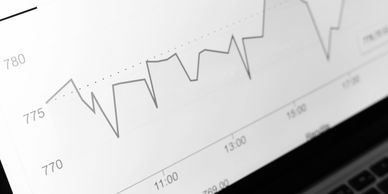 Close-up of a fluctuating financial graph on a screen.