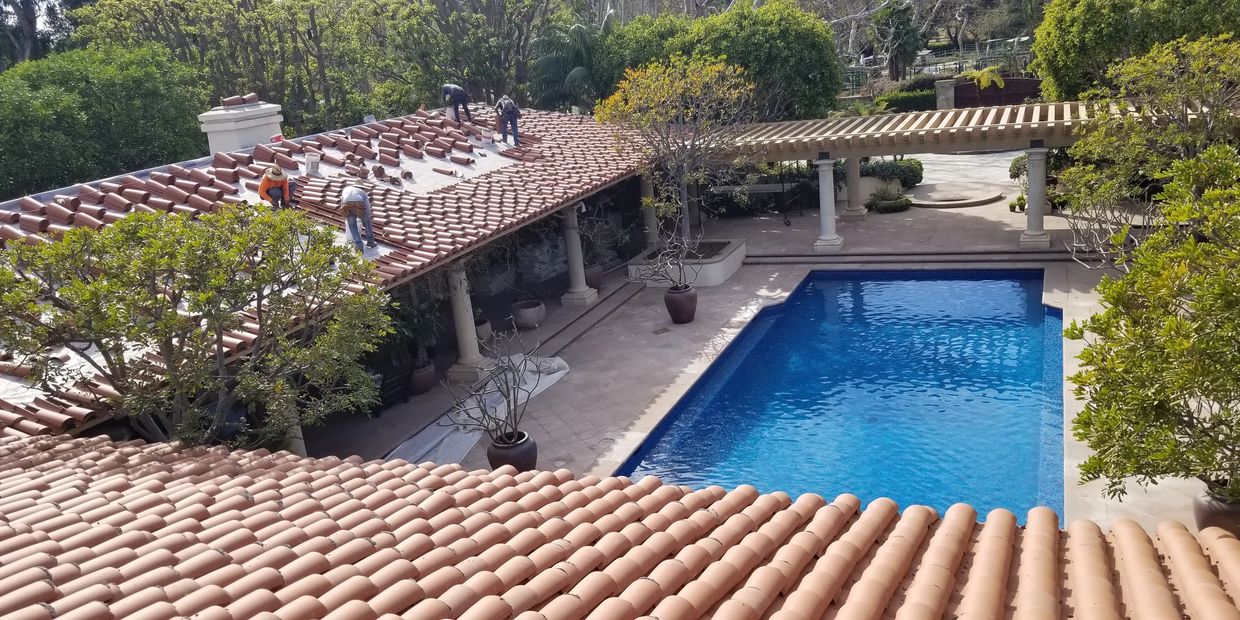 Tile roofing system on a home with Spanish-style architecture and pool