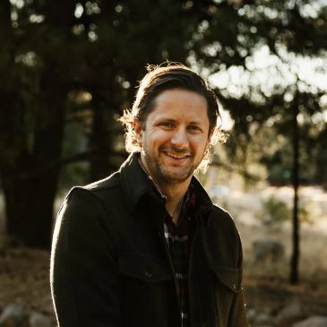 Smiling man outdoors in natural light.