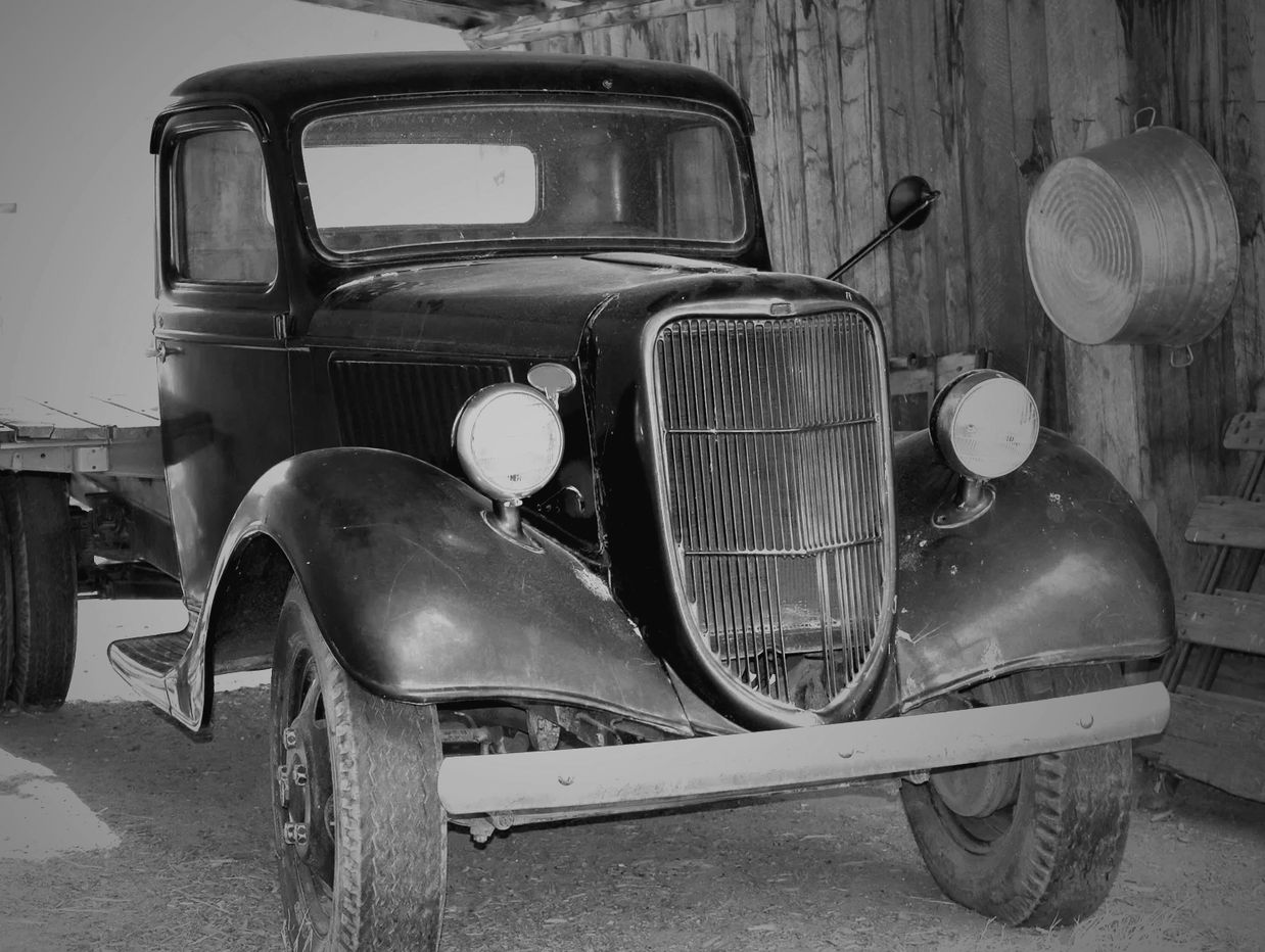 A vintage truck parked in a barn