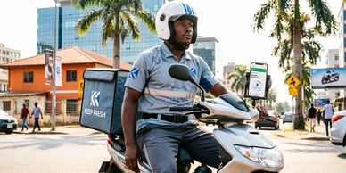 Delivery rider on a scooter navigating an urban street.