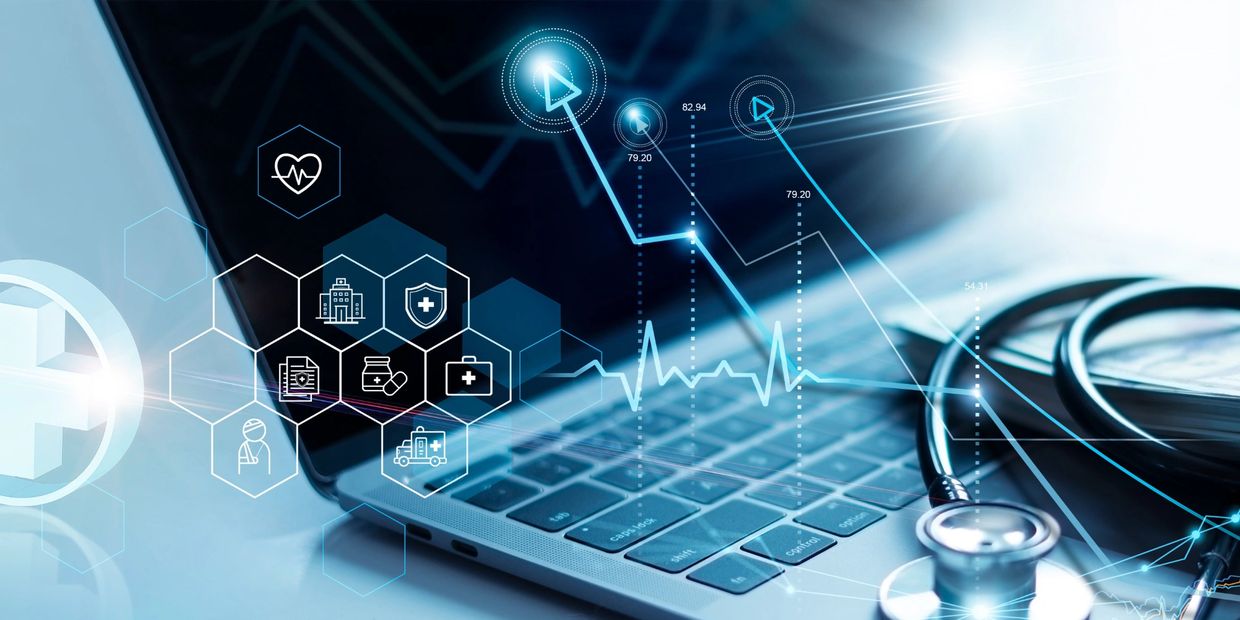 Digital healthcare concept with laptop, stethoscope, and medical icons.