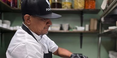 Chef preparing food in a kitchen.