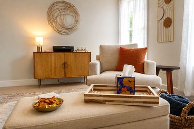 Cozy living room with beige furniture and warm decor.