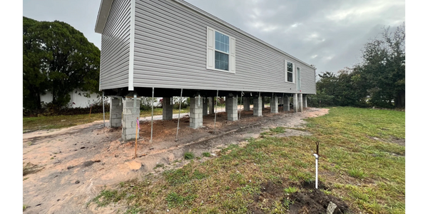mobile home installation in a flood zone with poured concrete foundation 