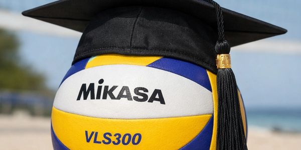 A volleyball wearing a graduation cap on a beach.