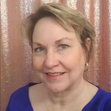 Smiling woman with short blonde hair against a sparkly pink background.