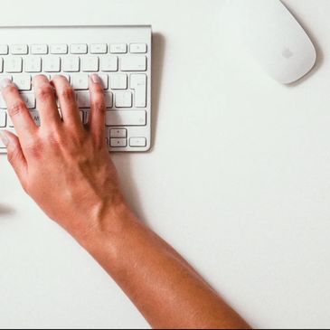 A hand and part of a keyboard.
