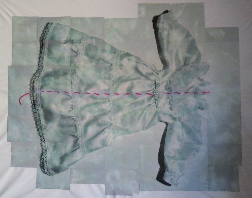 A satin dress with lace details and a pink dashed line down the center.