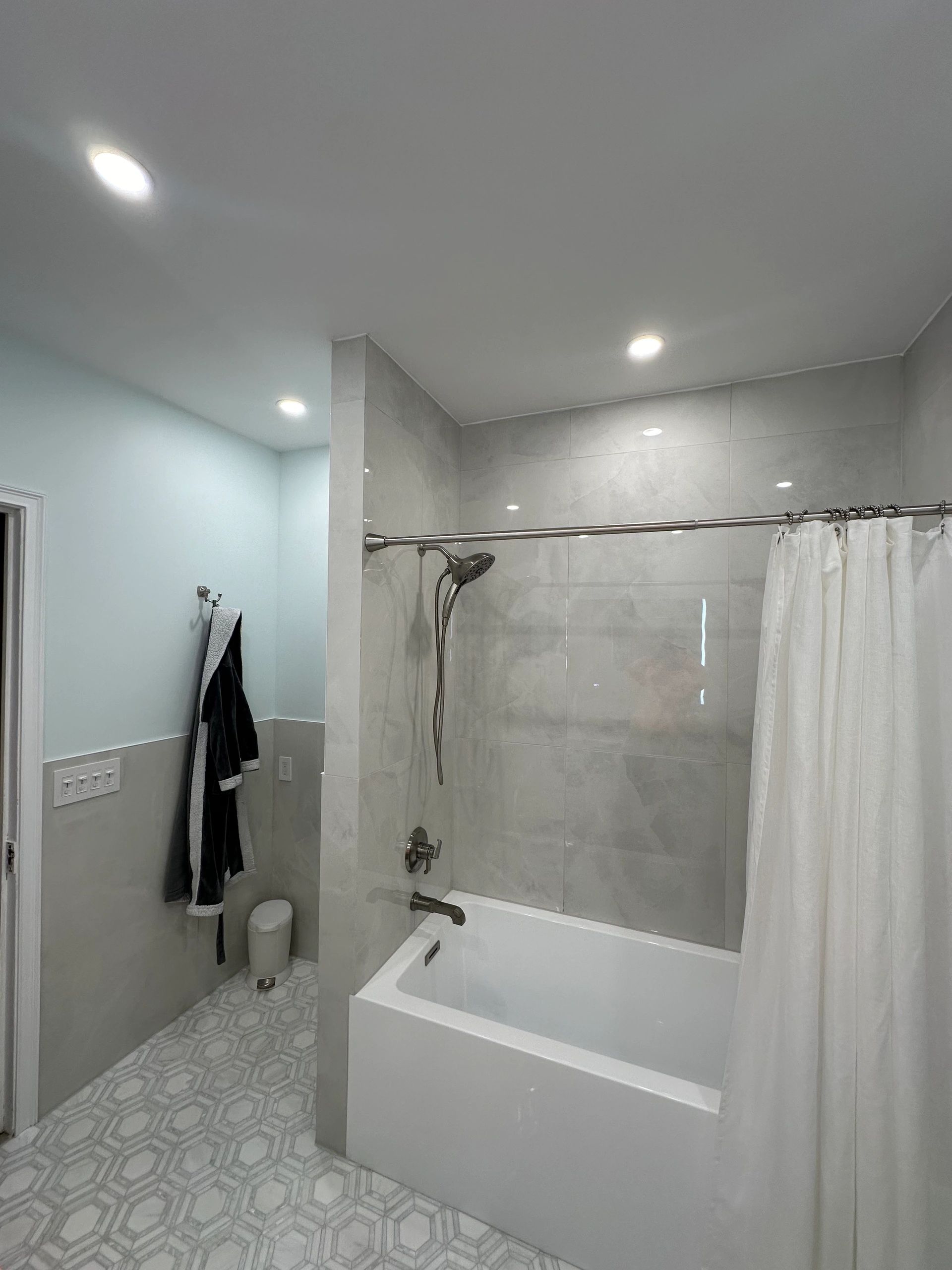 Modern bathroom with a bathtub and shower.