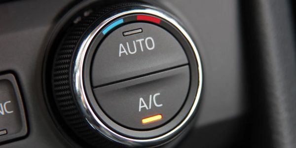 Close-up of a car's automatic air conditioning control knob.