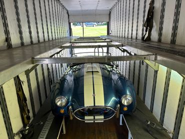 1966 Shelby Cobra being shipped inside an enclosed vehicle transport 