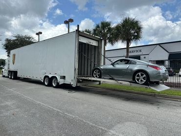 Nissan 350Z being shipped on a enclosed vehicle transport 