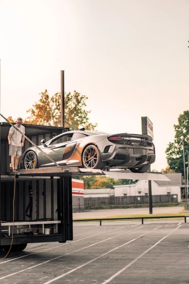 McLaren on a enclosed vehicle transport semi
