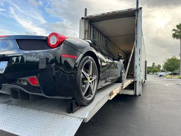 Ferrari being shipped and transported on an enclosed vehicle transport 