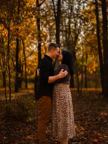 Couple embracing in an autumn forest at the guelph arboretum
