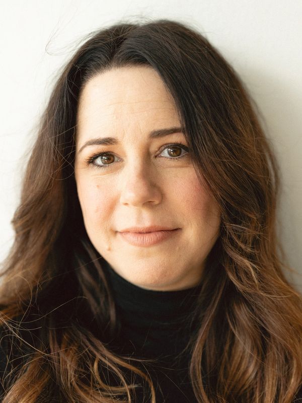 Portrait of a woman with long brown hair and a gentle smile.