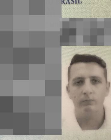 A black and white photo of a person's face on a document.