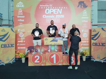 Winners on podium at Joinville SC Open Classic 2026 with trophies and prize money.