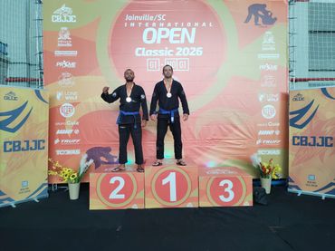 Two martial artists on a podium at Joinville SC International Open Classic 2026.