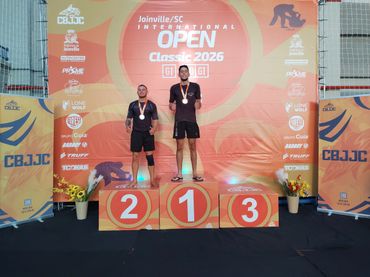 Two athletes on podium at Joinville Open Classic 2026 ceremony.