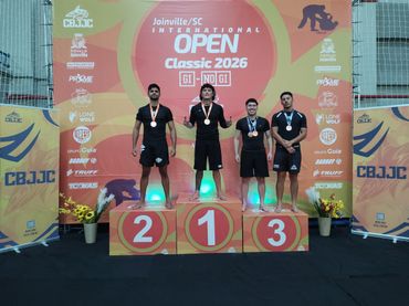 Four male athletes on podium at Joinville SC Open Classic 2026 award ceremony.