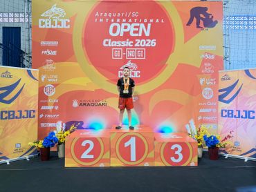 Athlete stands on first place podium at CBJJC International Open 2026.
