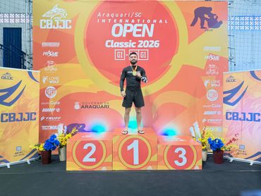 Athlete standing on the first-place podium at CBJJC Open Classic 2026 event.