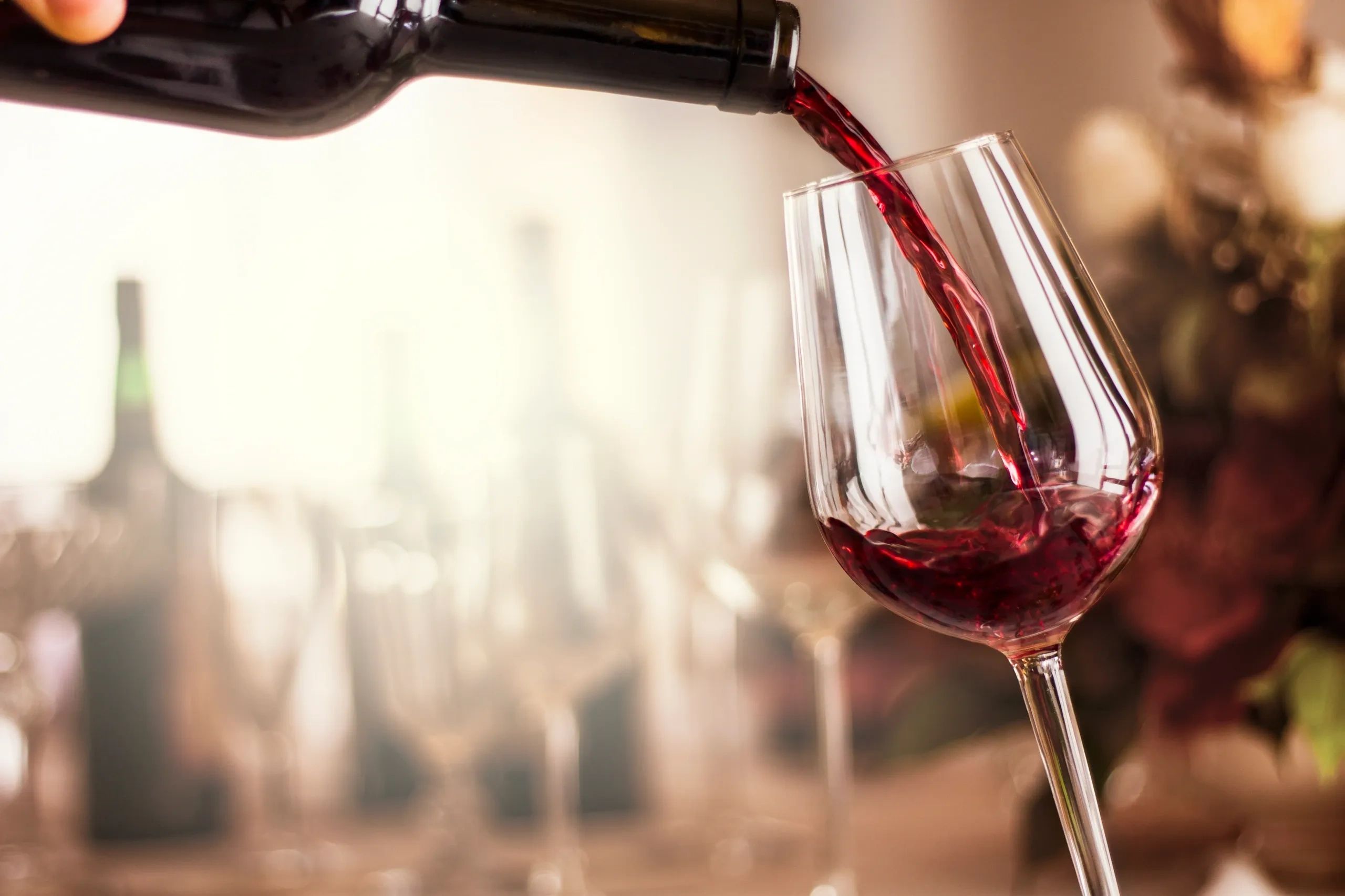 Red wine being poured into glass.