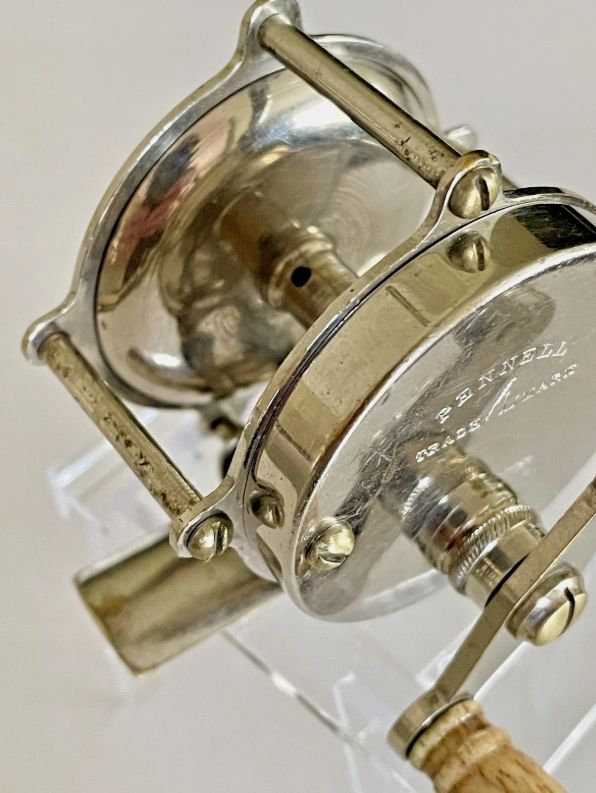 Close-up of a vintage Pennell fishing reel.