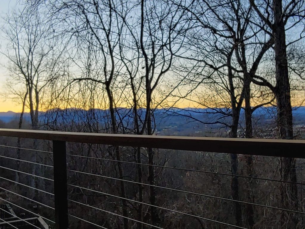 Amazing deck addition on Town Mountain, Asheville, NC. Ipe handrails with stainless steel railing.