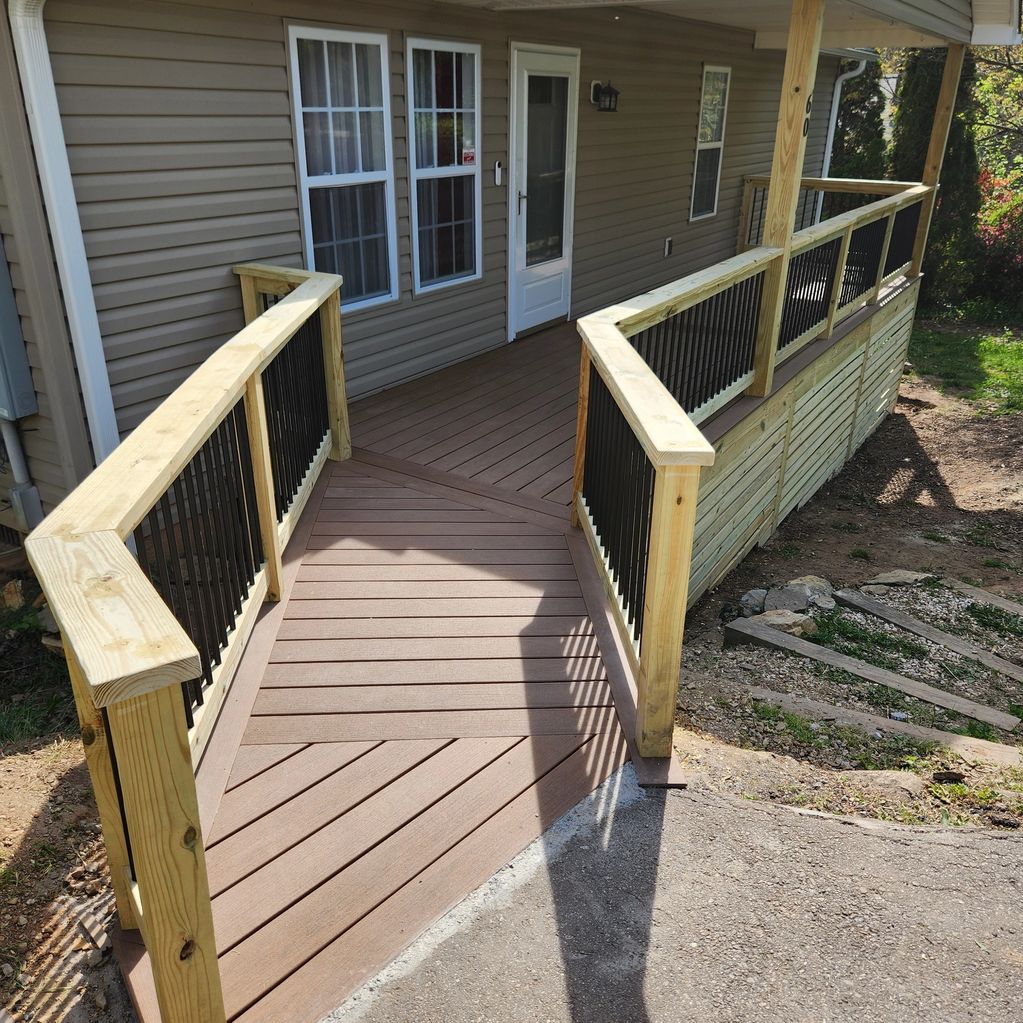 Trex deck addition in Asheville, NC using Trex Transcend Jasper decking and black metal railing.