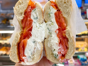 A bagel sandwich filled with cream cheese and smoked salmon.