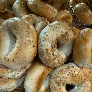 Close-up of assorted bagels with various seeds.