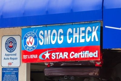 A sign indicating a company near Solana Beach, CA, does a smog check