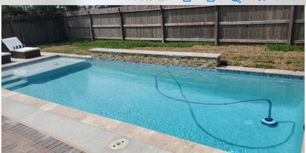Clean backyard pool with robotic cleaner.