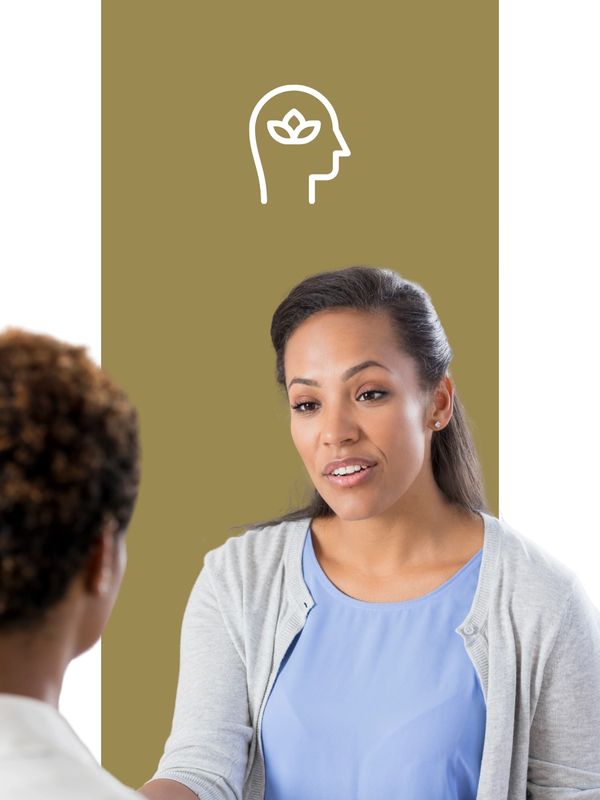 Two women engaged in a meaningful conversation about mental wellness.