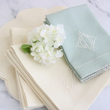 selection of cream and green monogrammed placemats, napkins and guest towels.