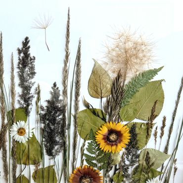 A delicate arrangement of dried flowers and leaves.