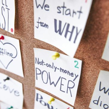 Notes with motivational messages on a corkboard.