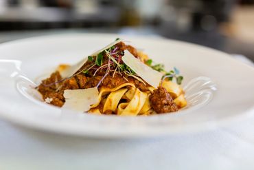Close-up of noodles and pasta served on a white plate

