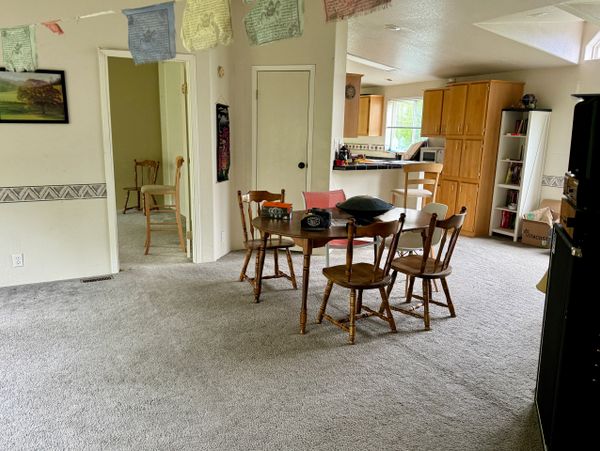 Cozy dining area with wooden chairs and table in an open living space.