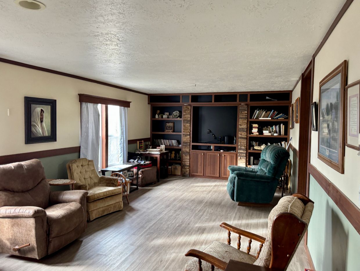 Cozy living room with recliners and a large entertainment center.