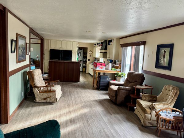 Cozy living room with vintage armchairs and wooden flooring.